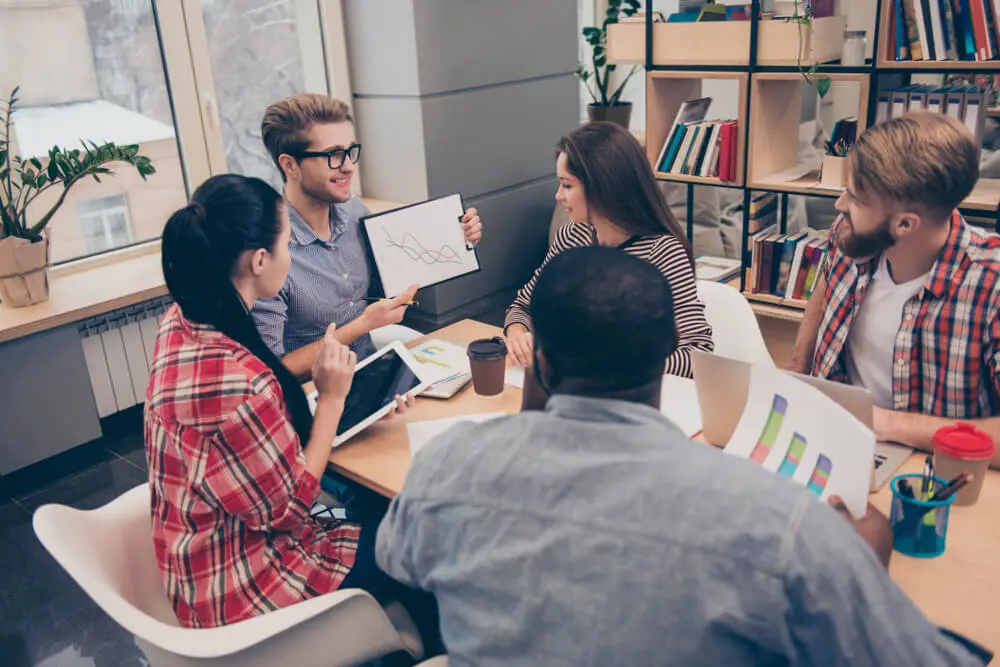 Young man presenting his ideas to colleagues on meeting